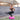 woman balances on one leg on a bosu balance trainer